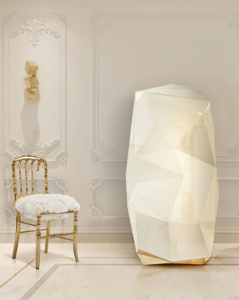 luxury safes- gold chair and white fur, white walls, gold wall lamp, cream safe