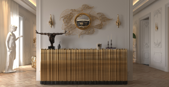 It's an entrance with a sideboard, a mirrored watermark, the walls are white, and there's a statue.